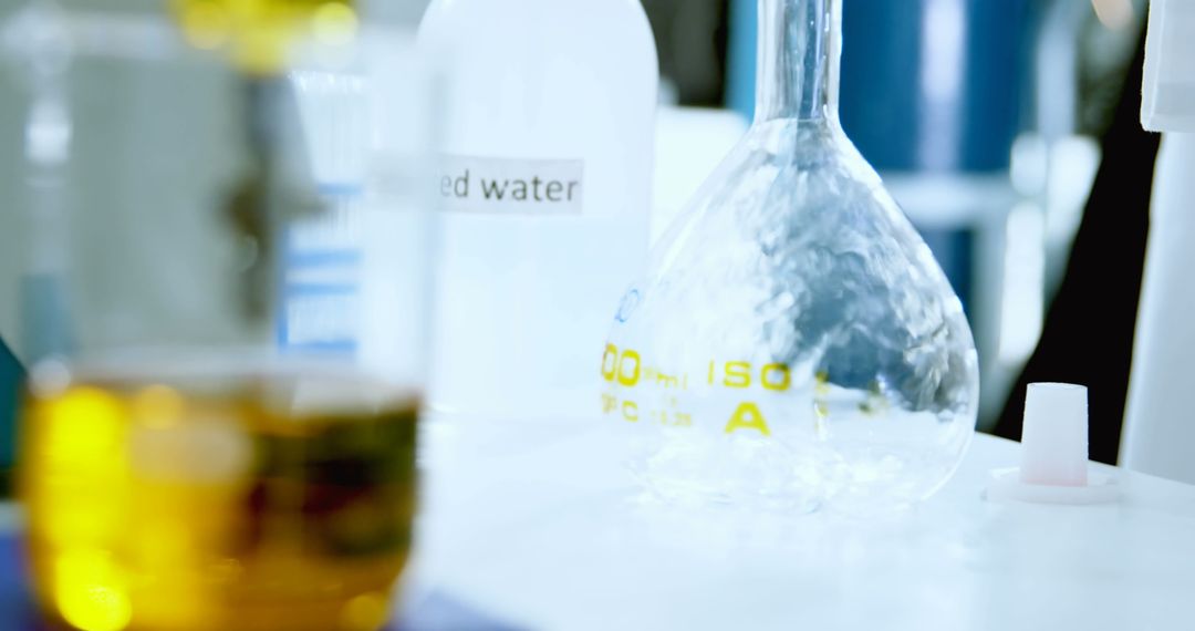 Caucasian Scientist Conducting Experiment with Flasks in Laboratory