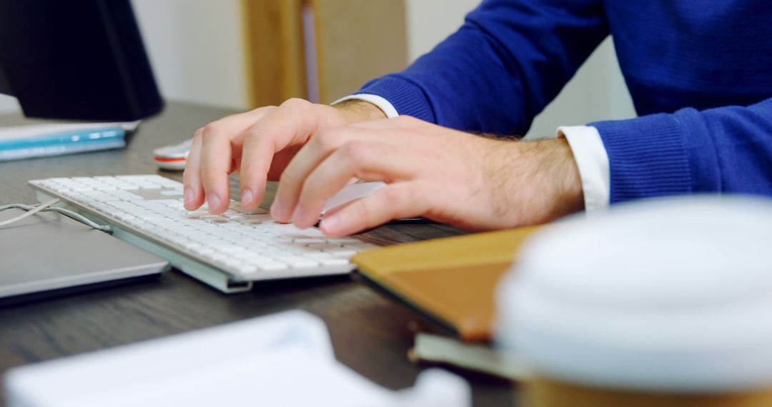 Close-Up of Hands Typing on Keyboard in Modern Office