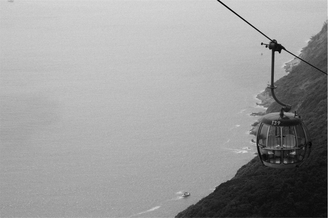 Cable Car Over Coastal Landscape in Black and White - Free Images, Stock Photos and Pictures on Pikwizard.com