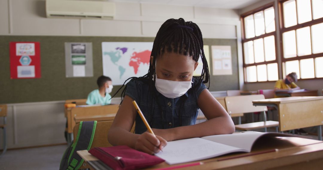 Young Girl Wearing Face Mask Studying in Classroom - Free Images, Stock Photos and Pictures on Pikwizard.com