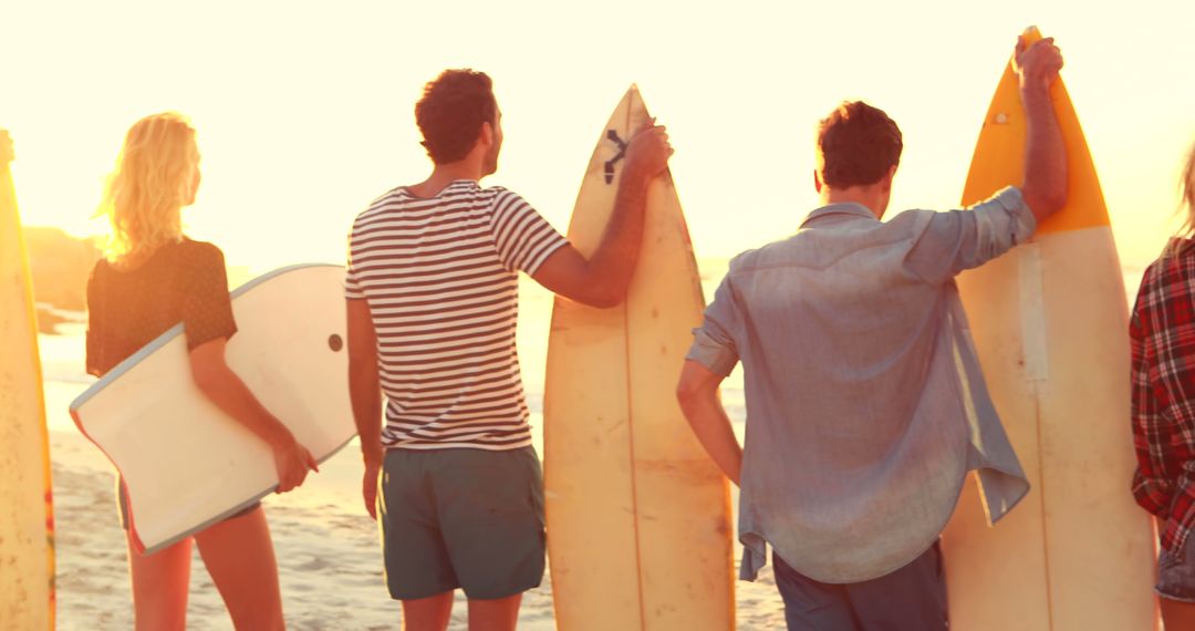 Friends with Surfboards Standing on Beach at Sunset - Free Images, Stock Photos and Pictures on Pikwizard.com