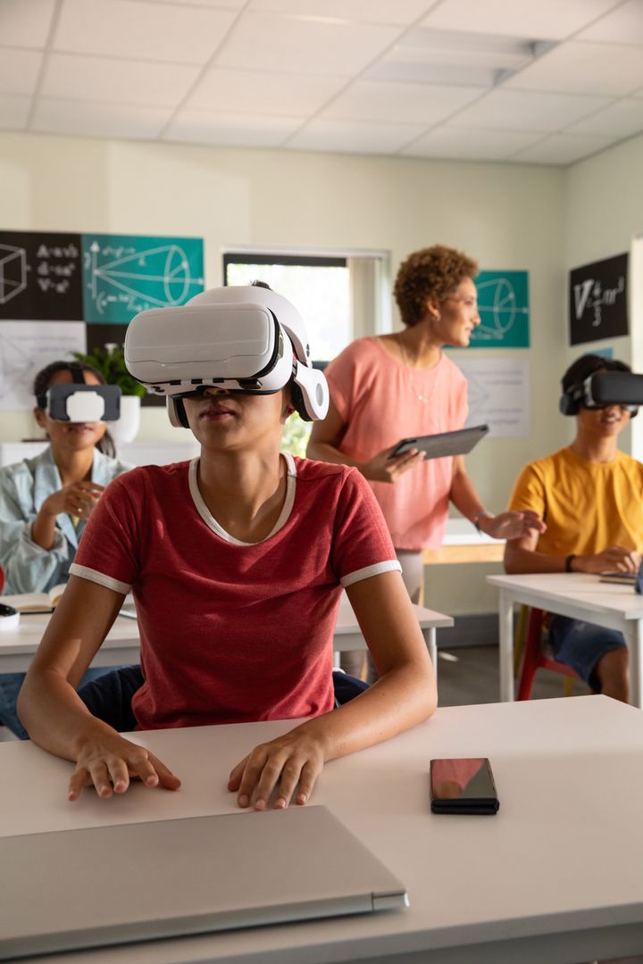 Chinese Woman Student Wearing VR Headset in Classroom with Teacher Guiding Using Tablet