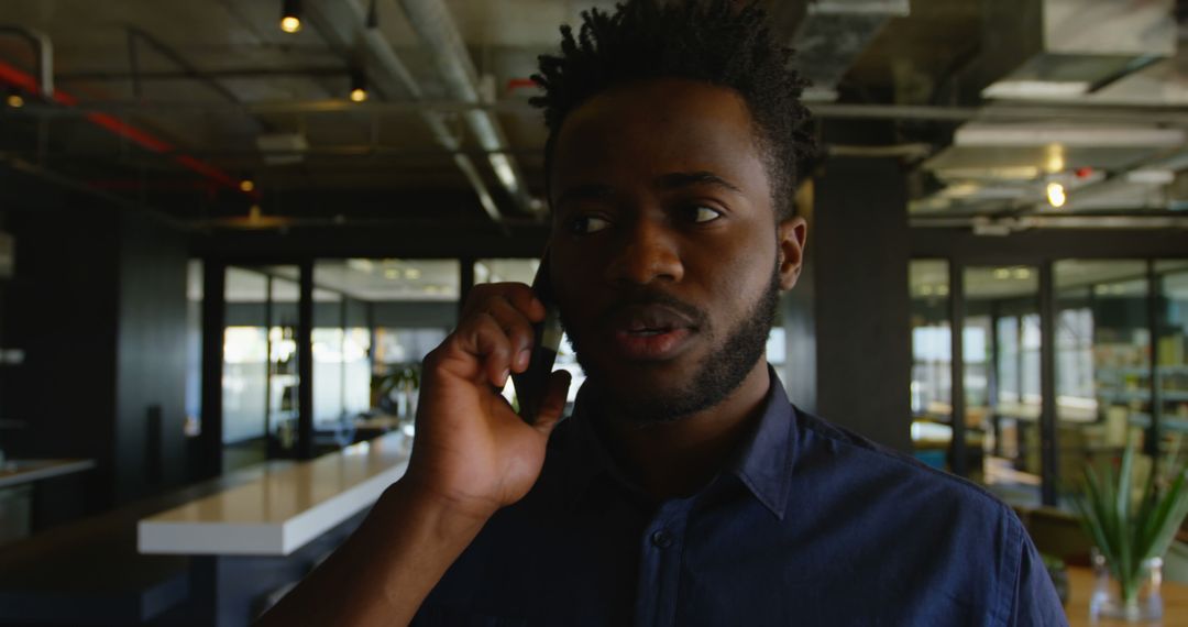 Man Talking on Phone in Modern Office - Free Images, Stock Photos and Pictures on Pikwizard.com