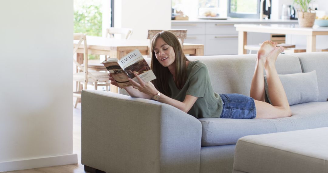 Woman Relaxing on Sofa Reading a Book in Peaceful Home Setting