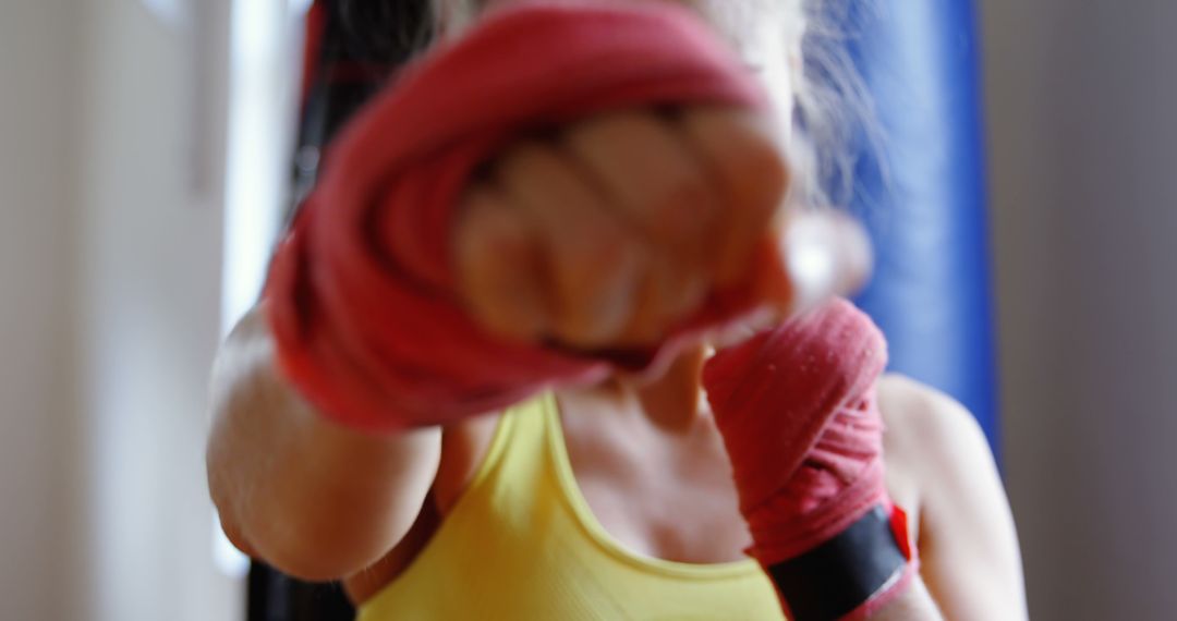 Female Boxer Practicing Punch with Focus on Hand Wraps - Free Images, Stock Photos and Pictures on Pikwizard.com