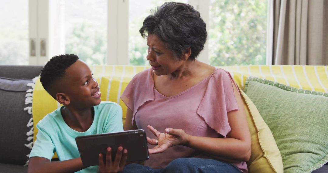 Grandmother and Grandson Using Tablet for Learning at Home