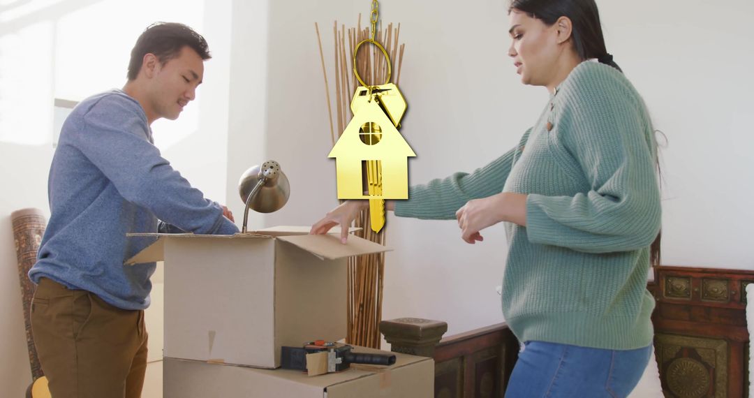 Couple Packing Boxes with Gold Key Symbolizing New Home