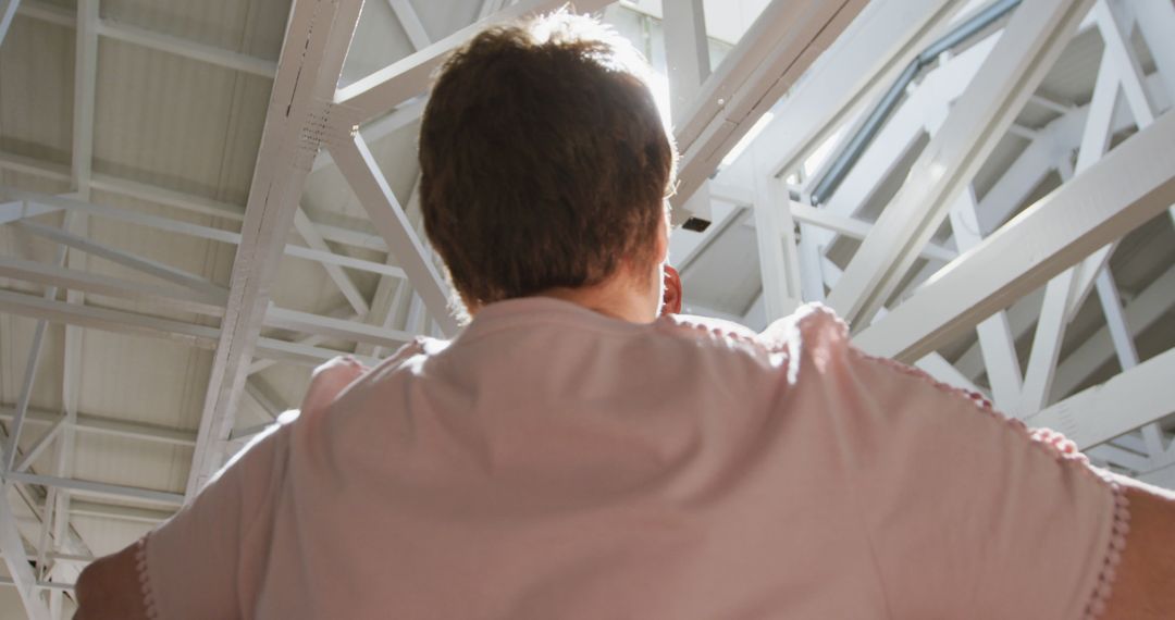 Person Reflecting Under Modern Skylight in Industrial Building - Free Images, Stock Photos and Pictures on Pikwizard.com