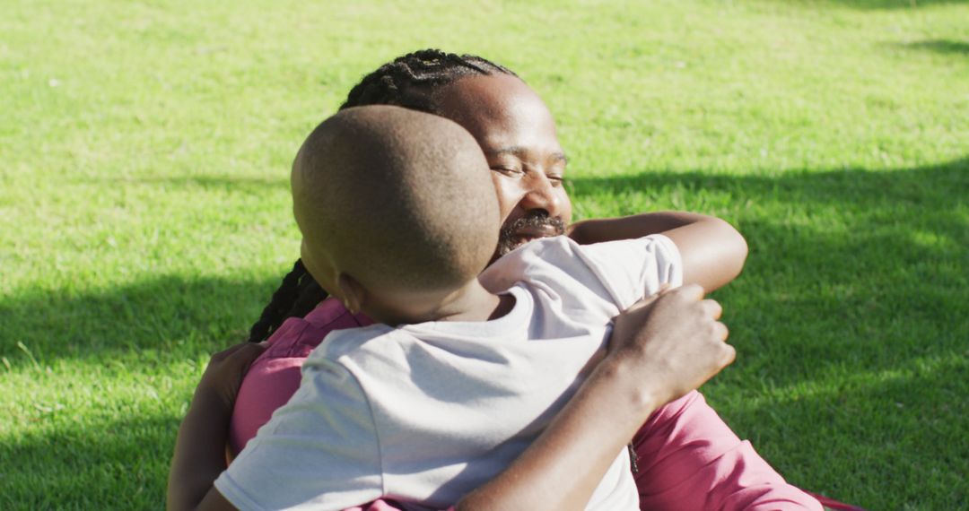 Loving Father Embracing Son Outdoors on Sunny Day - Free Images, Stock Photos and Pictures on Pikwizard.com