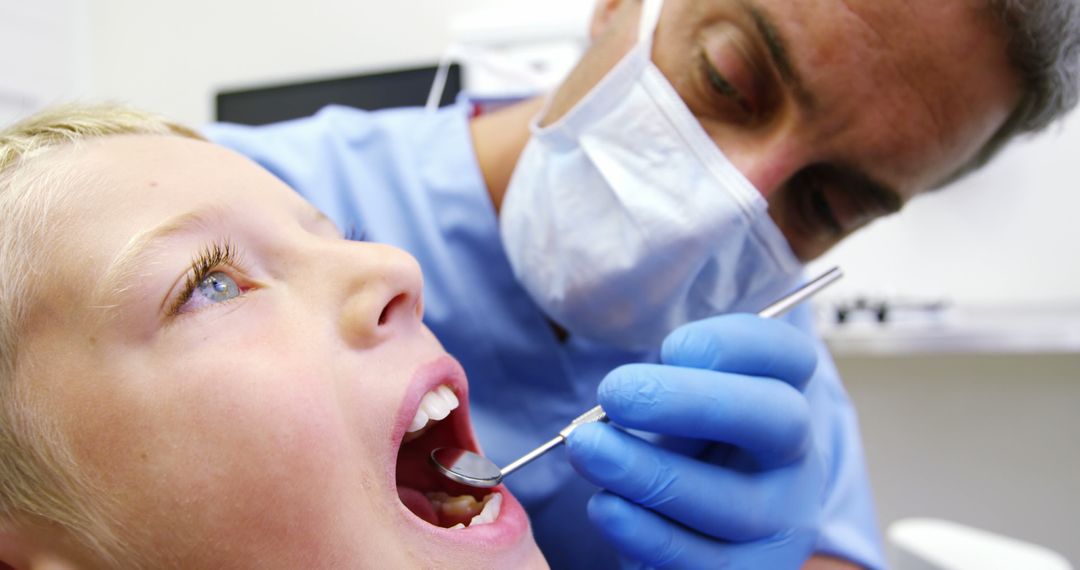 Child Receiving Dental Check-Up from Male Dentist - Free Images, Stock Photos and Pictures on Pikwizard.com