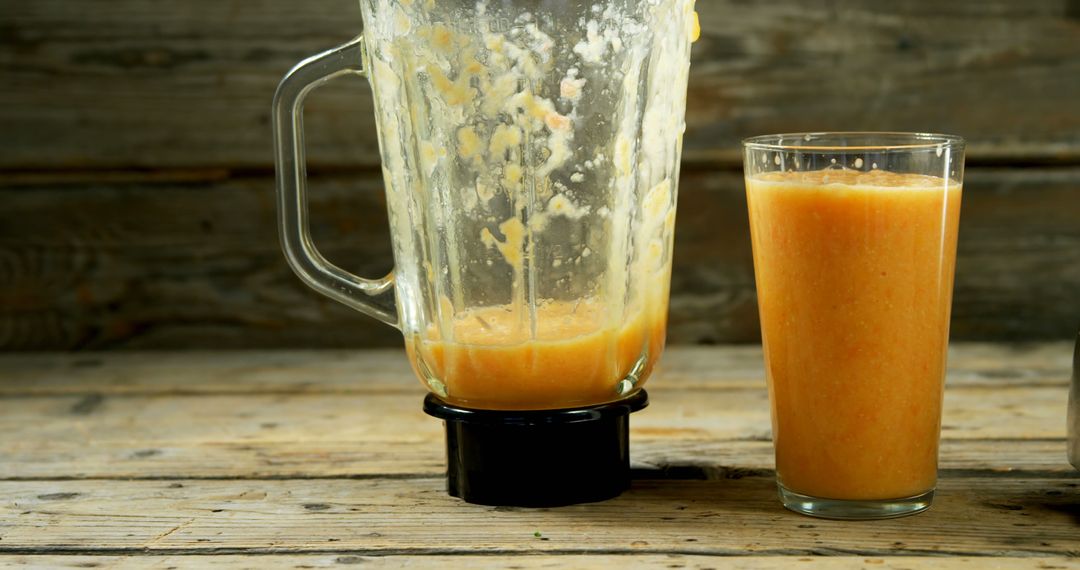 Fresh Peach Smoothie in Blender and Glass on Rustic Wooden Table - Free Images, Stock Photos and Pictures on Pikwizard.com