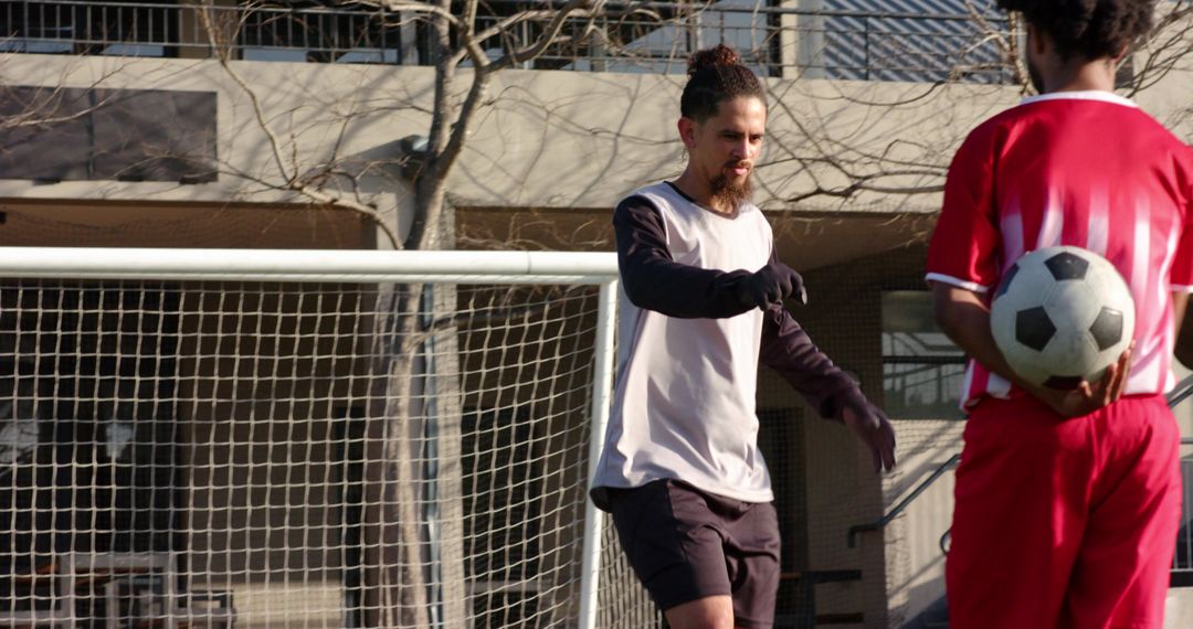 Goalkeeper Demonstrating Agile Save on Sunlit Soccer Field