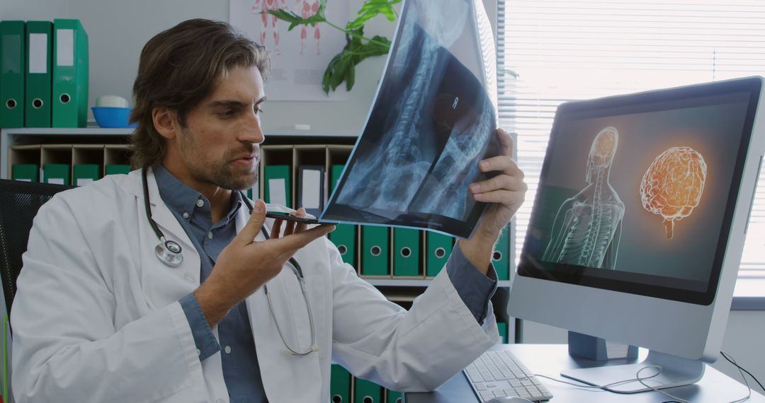 Doctor Examining X-Ray Image Speaking into Dictaphone in Modern Medical Office - Free Images, Stock Photos and Pictures on Pikwizard.com