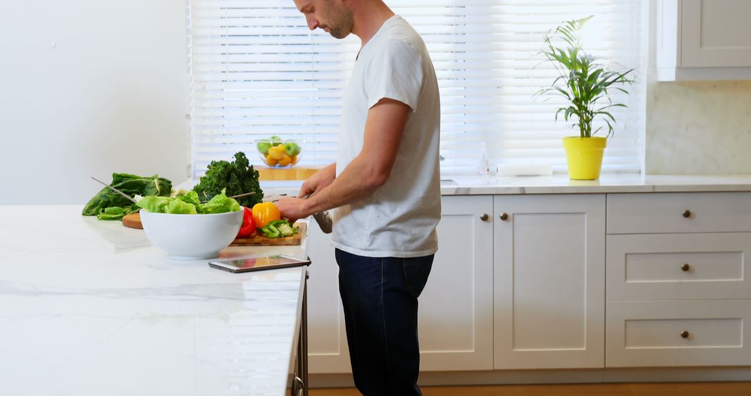 Man Preparing Fresh Vegetables in Bright Modern Kitchen - Free Images, Stock Photos and Pictures on Pikwizard.com