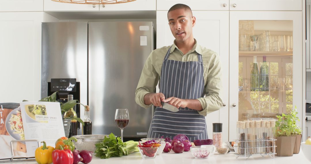 Man Preparing Meal in Modern Kitchen with Various Fresh Vegetables - Free Images, Stock Photos and Pictures on Pikwizard.com