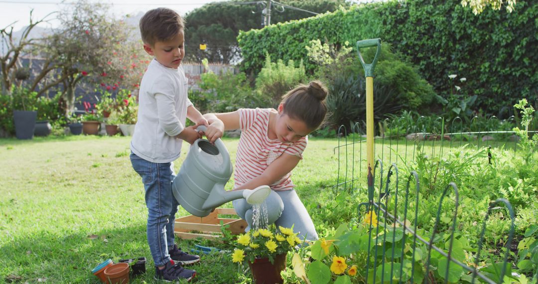 Children Watering Plants in Backyard Garden on Sunny Day - Free Images, Stock Photos and Pictures on Pikwizard.com