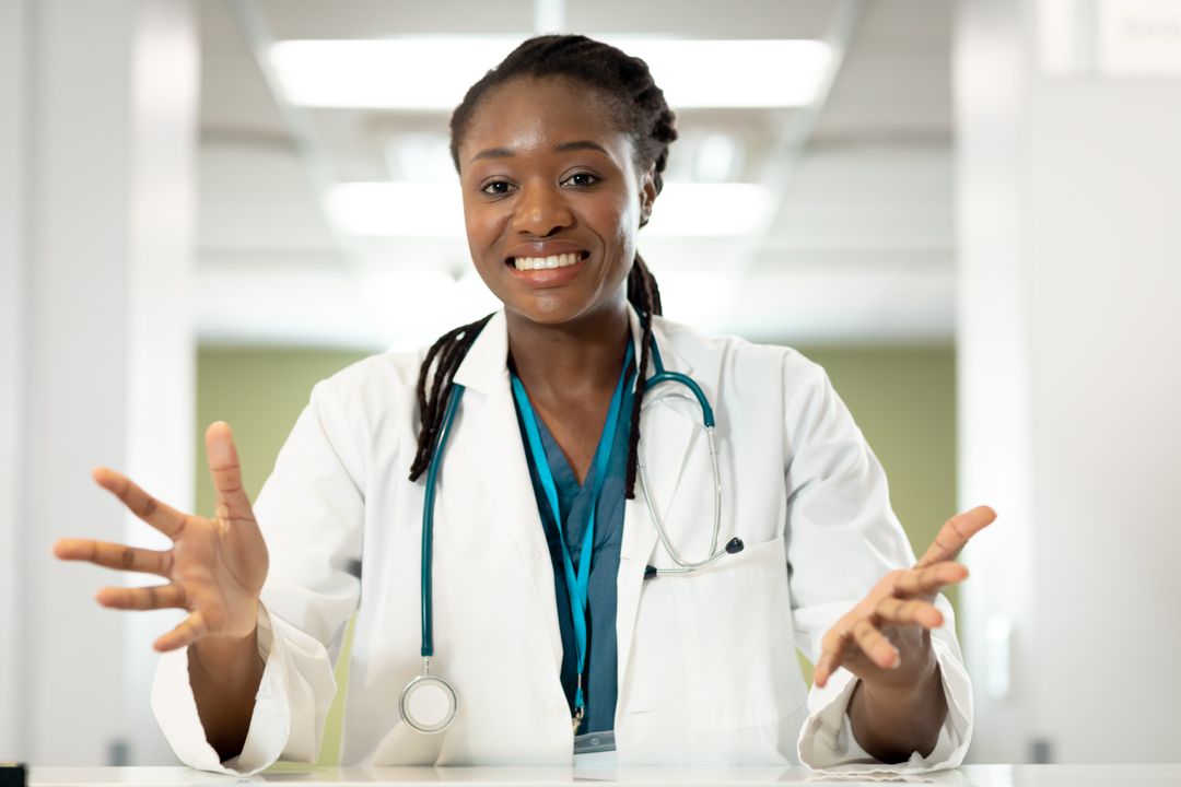 Smiling African American Female Doctor Gesturing During Video Call Consultation - Free Images, Stock Photos and Pictures on Pikwizard.com