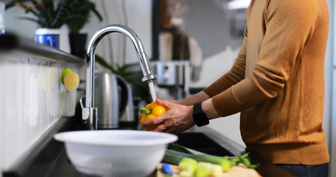 Person Washing Bell Pepper in Kitchen Under Faucet - Free Images, Stock Photos and Pictures on Pikwizard.com