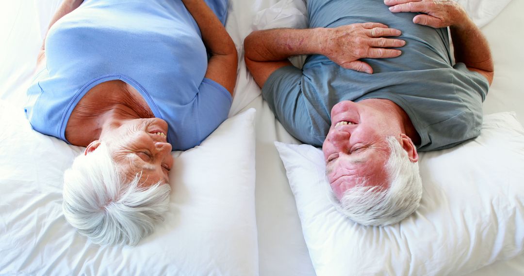 Happy Senior Couple Laughing Together in Bed - Free Images, Stock Photos and Pictures on Pikwizard.com