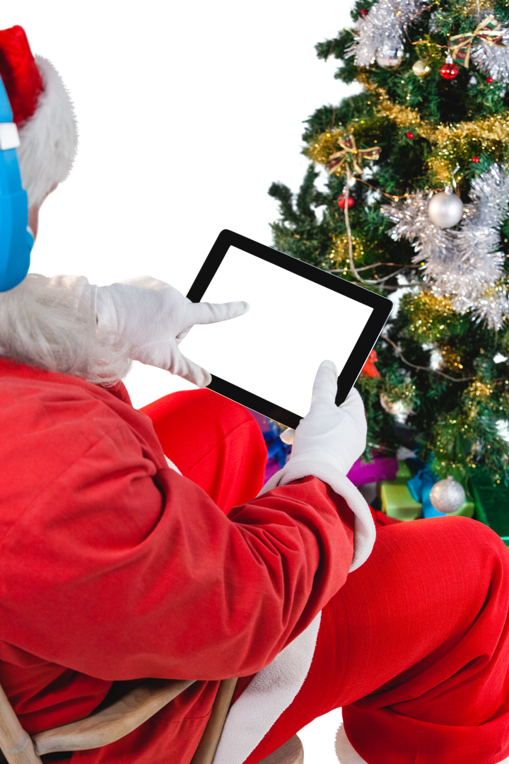 Transparent Santa Claus Engaging with Digital Tablet Beside Christmas Tree - Download Free Stock Images Pikwizard.com