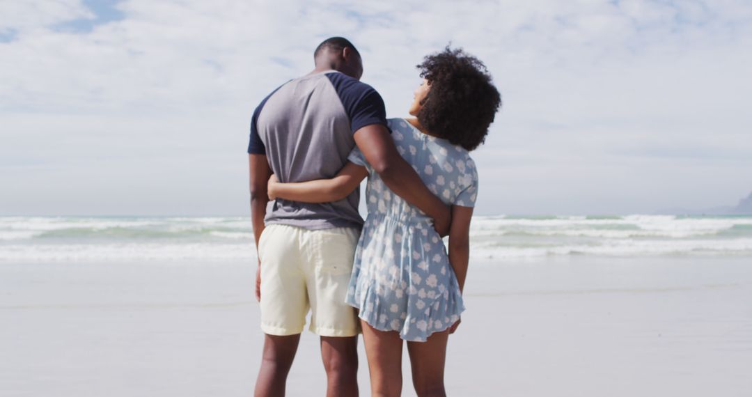 African american couple embracing and smiling at the beach - Free Images, Stock Photos and Pictures on Pikwizard.com