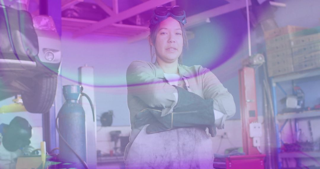 Female Mechanic With Crossed Arms in Workshop Displaying Confidence
