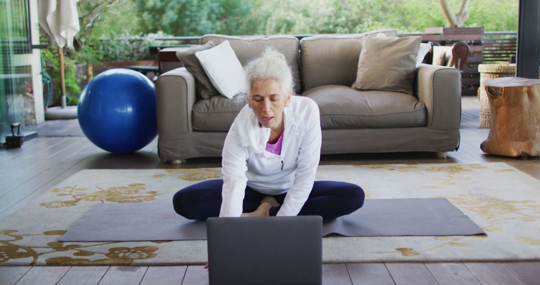 Senior Woman Doing Yoga Practice on Laptop at Home - Free Images, Stock Photos and Pictures on Pikwizard.com