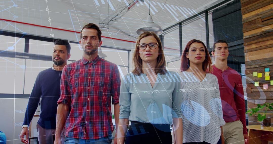 Confident Team Walking in Modern Office with Overlaying Graphs