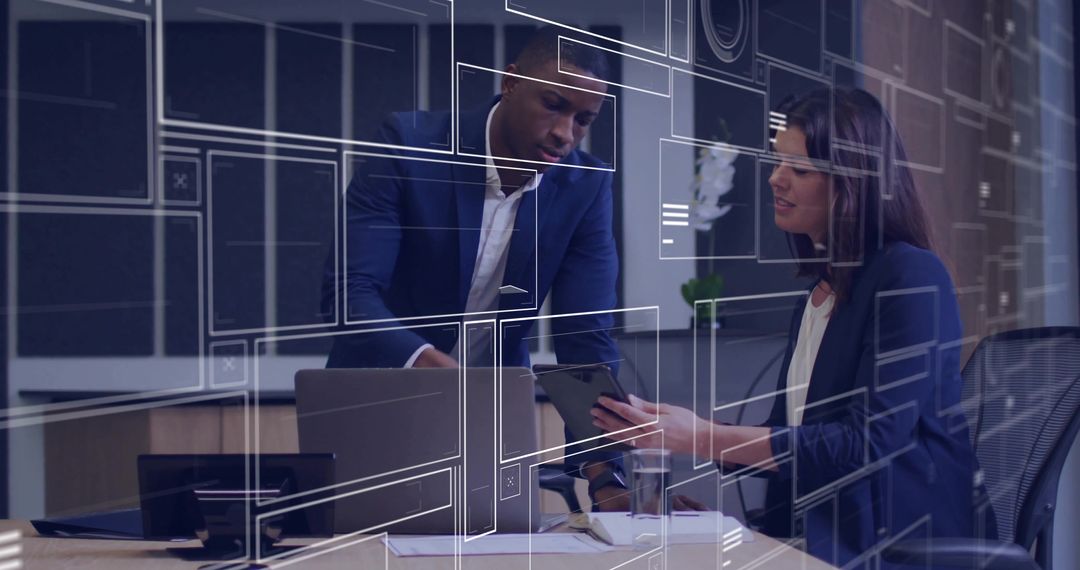 Colleagues collaborating over tablet and laptop with digital HUD overlays in modern office