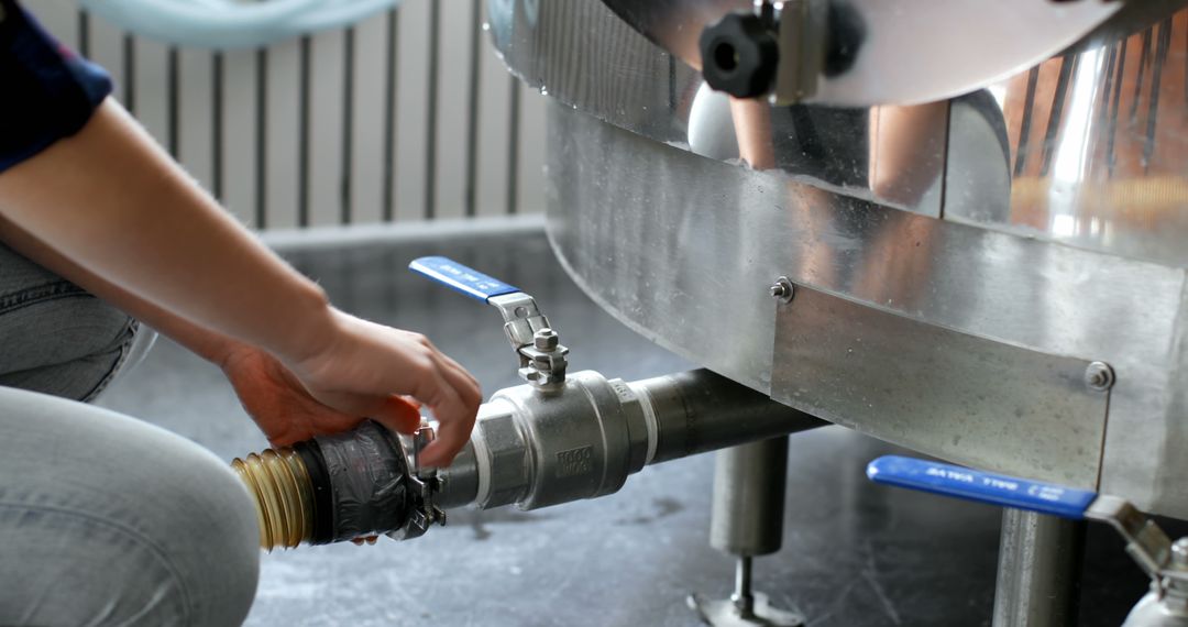 Technician Adjusting Industrial Valve in Brewery - Free Images, Stock Photos and Pictures on Pikwizard.com