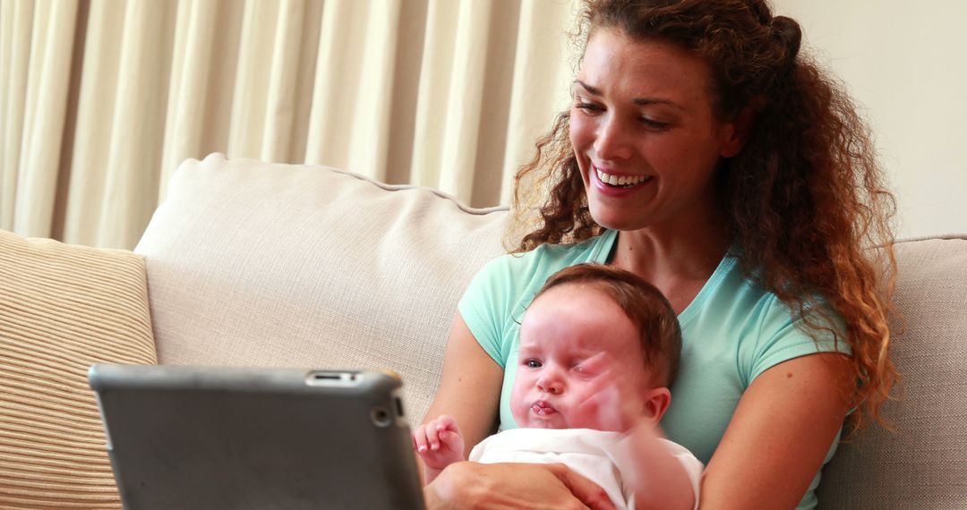 Smiling Mother with Baby Video Chatting at Home - Free Images, Stock Photos and Pictures on Pikwizard.com