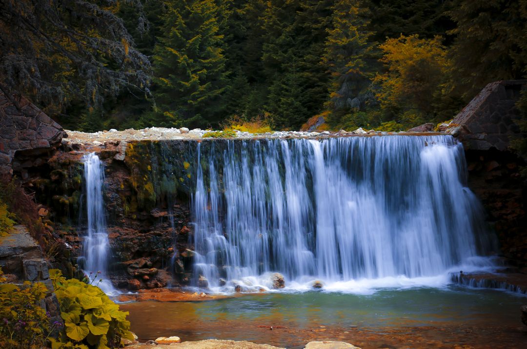 Serene Waterfall in Forest Landscape During Fall Season - Free Images, Stock Photos and Pictures on Pikwizard.com