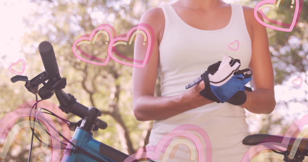 Cyclist Preparing for Ride with Gloves and Bicycle in Park