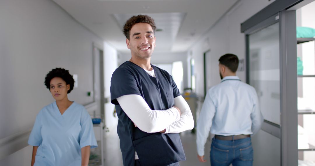 Confident Medical Professional Standing in Hospital Corridor - Free Images, Stock Photos and Pictures on Pikwizard.com