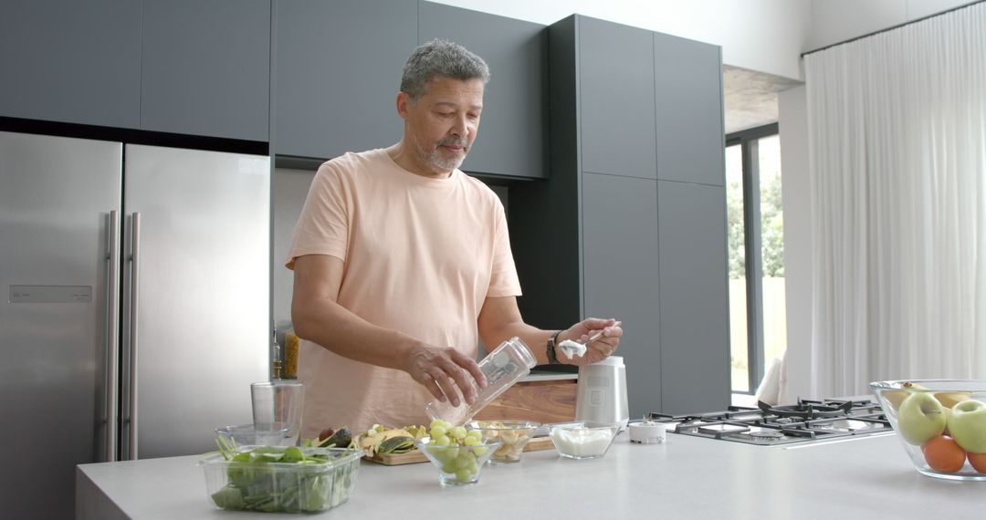 Mature Man Preparing Healthy Smoothie in Modern Kitchen at Home - Free Images, Stock Photos and Pictures on Pikwizard.com