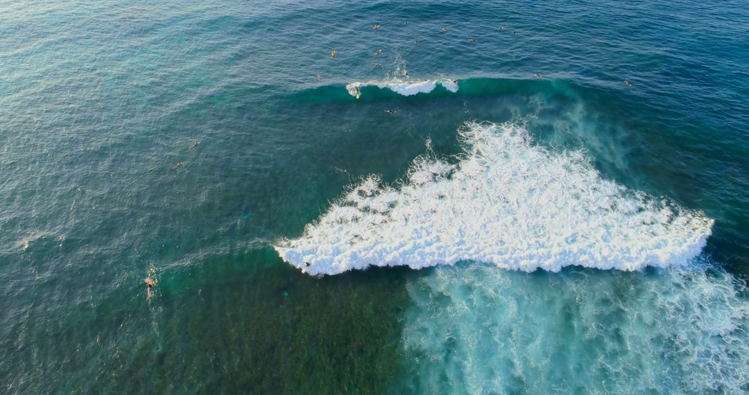 Aerial View of Ocean Waves and Surfers in Blue Sea - Free Images, Stock Photos and Pictures on Pikwizard.com