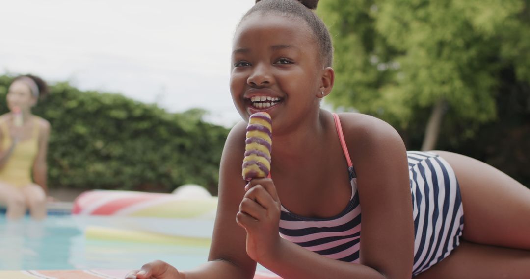 Smiling Girl Eating Colorful Ice Cream by Poolside - Free Images, Stock Photos and Pictures on Pikwizard.com