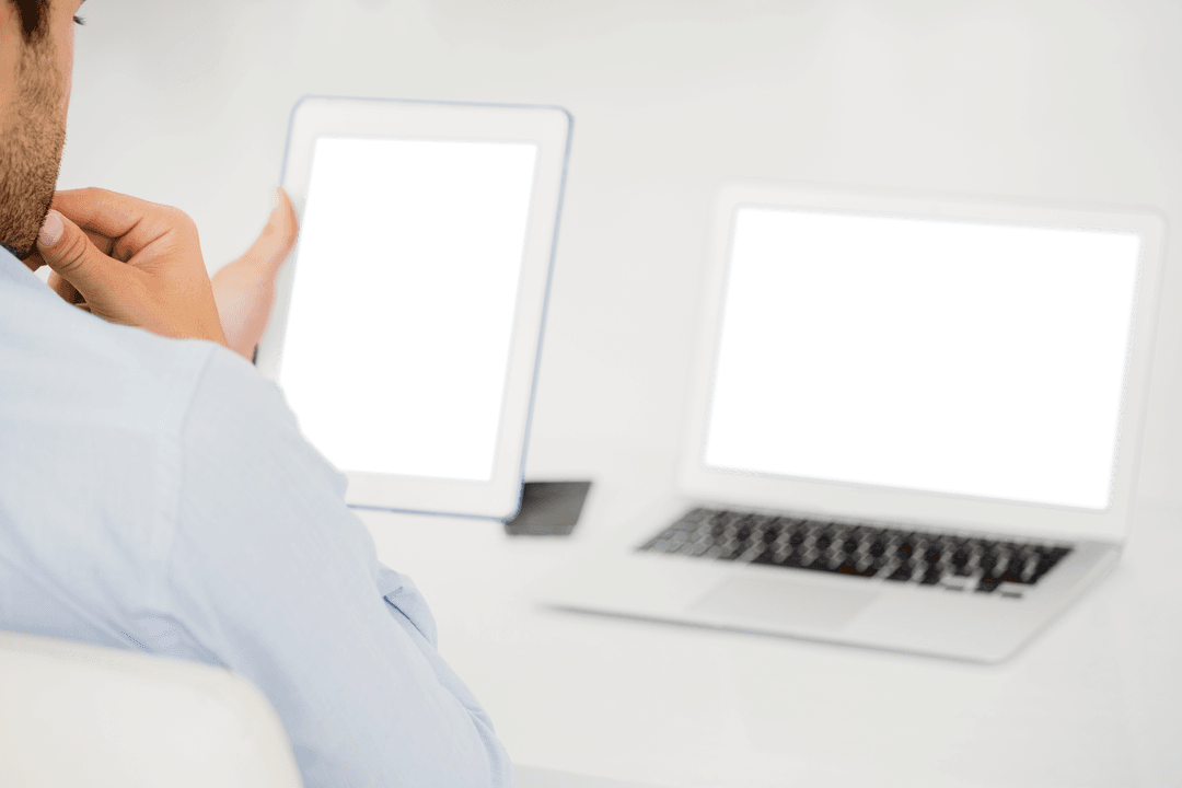 Businessman Multitasking with Tablet and Laptop Transparent Screens