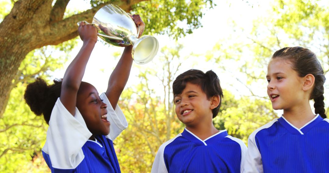 Excited Children Holding Trophy Celebrating Soccer Victory - Free Images, Stock Photos and Pictures on Pikwizard.com