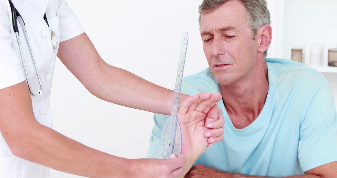 Elderly Man Receiving Physical Therapy Assistance from Medical Professional - Free Images, Stock Photos and Pictures on Pikwizard.com