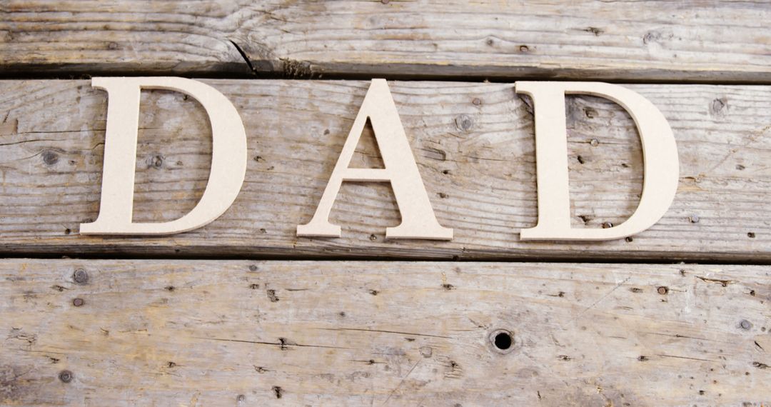 Wooden Letters Spelling DAD on Rustic Wooden Background - Free Images, Stock Photos and Pictures on Pikwizard.com