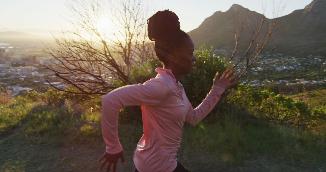 African American Woman Jogging Outdoors with Scenic Mountain View at Sunrise - Free Images, Stock Photos and Pictures on Pikwizard.com