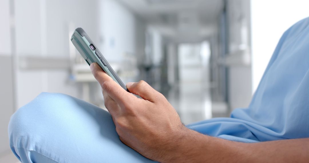 Patient Using Smartphone in Hospital Waiting Room - Free Images, Stock Photos and Pictures on Pikwizard.com