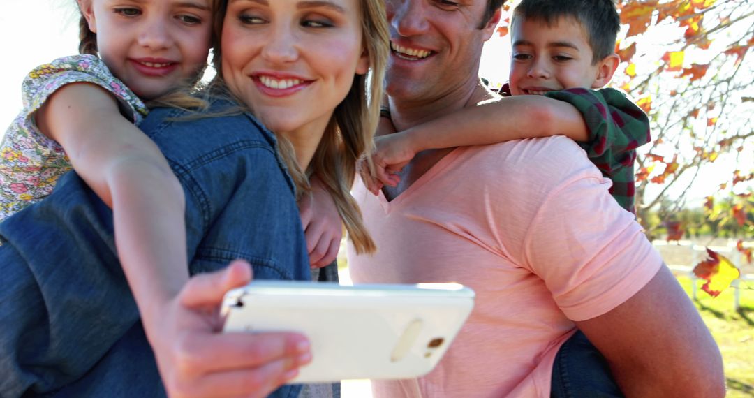 Smiling Family Taking Selfie at Park - Free Images, Stock Photos and Pictures on Pikwizard.com