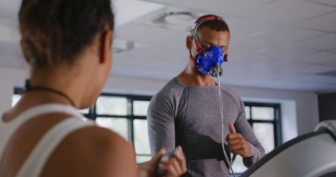 Man Running on Treadmill with Respiratory Mask during Fitness Assessment - Free Images, Stock Photos and Pictures on Pikwizard.com