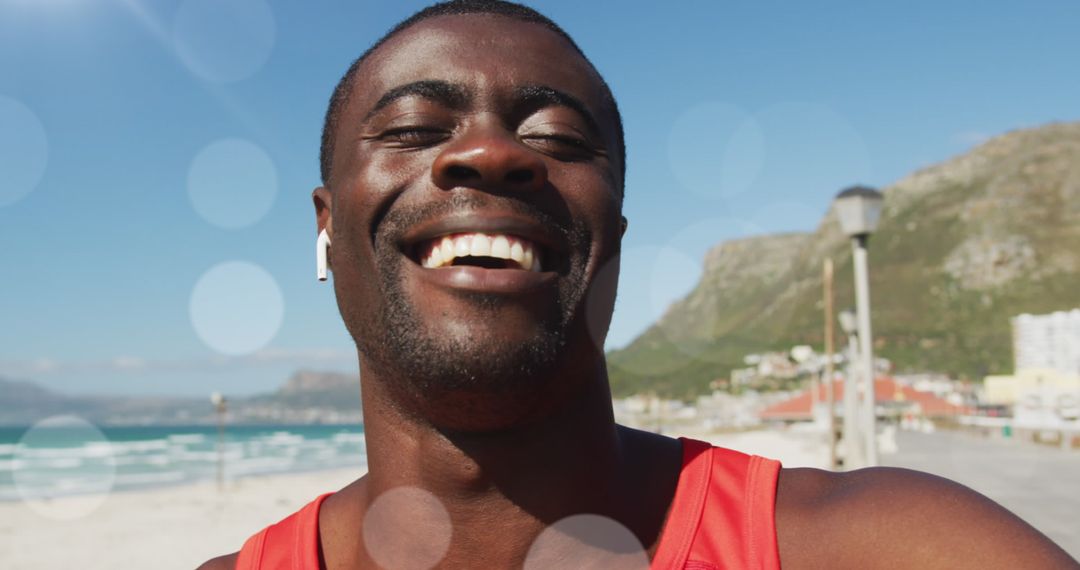 Smiling Man Exercising Outdoors Takes Call by the Ocean
