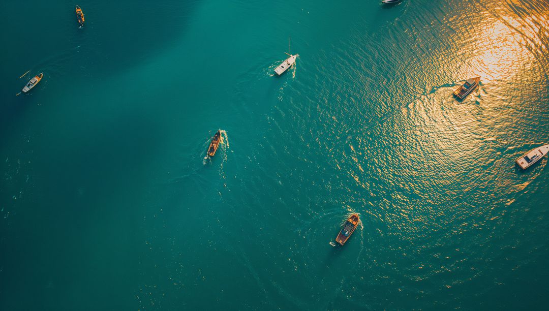 Sunlit Teal Bay with Boats Gliding and Leaving Wake Trails — Aerial Seascape