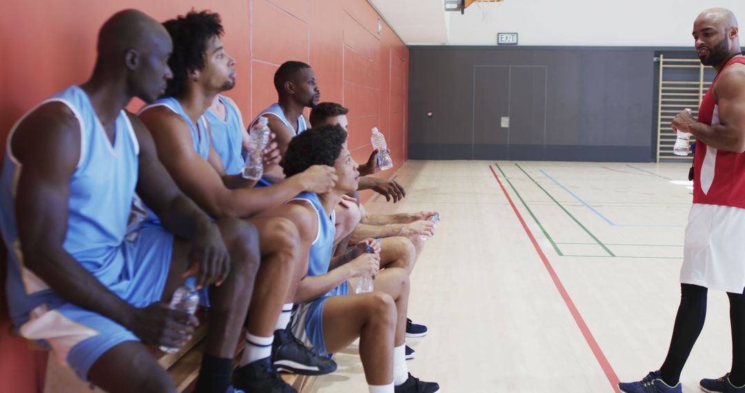 Basketball Coach Motivating Enthusiastic Team on Bench - Free Images, Stock Photos and Pictures on Pikwizard.com