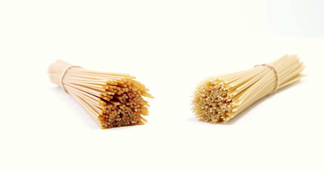 Two Bundles of Dry Spaghetti Isolated on White Background - Free Images, Stock Photos and Pictures on Pikwizard.com