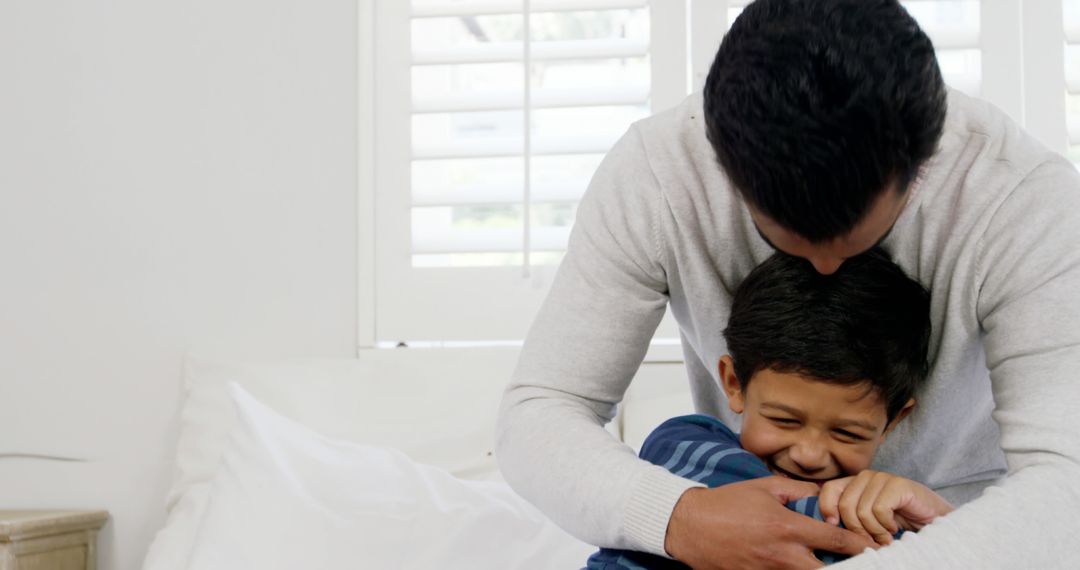 Father Hugging Son in Warm Family Moment - Free Images, Stock Photos and Pictures on Pikwizard.com